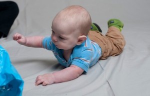 Reaching for toys while on the tummy strengthens back, neck and arm muscles.